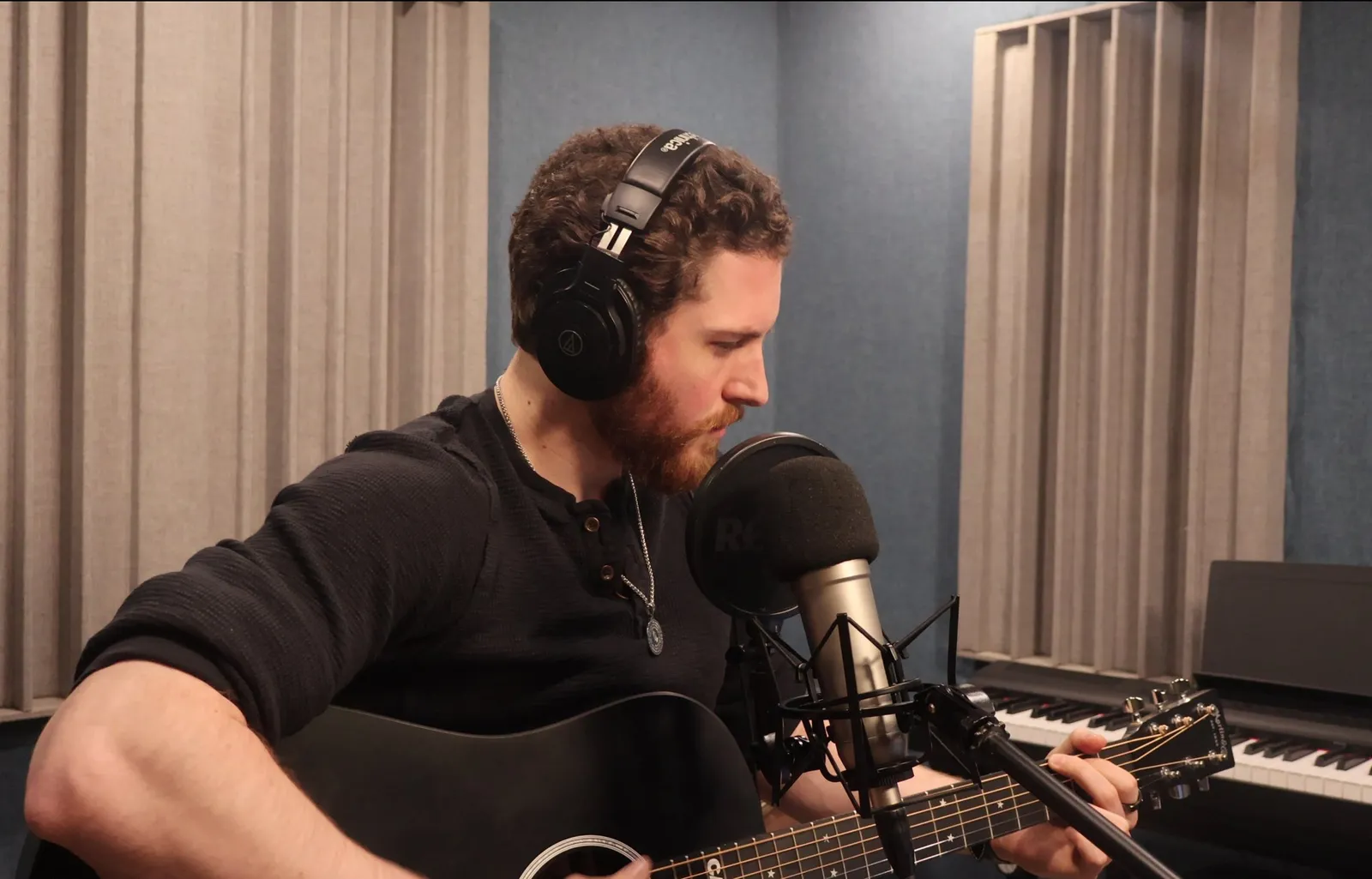 John Matthew Gillen recording vocals and acoustic guitar in a music studio